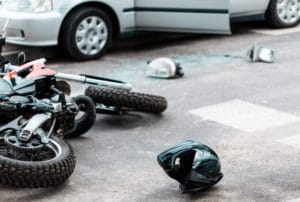 Image of a motorcycle lying on the ground after a crash