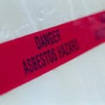 Image of red tape labeled "Danger: Asbestos Hazard"