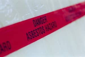 Image of red tape labeled "Danger: Asbestos Hazard"