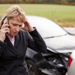 Image of woman on phone after car wreck