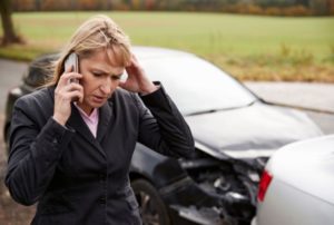 Image of woman on phone after car wreck