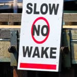 Image of a "No Wake" sign at a marina