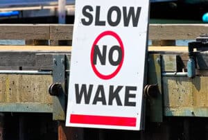 Image of a "No Wake" sign at a marina
