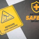Image of a trip hazard warning sign with the National Safety Month logo